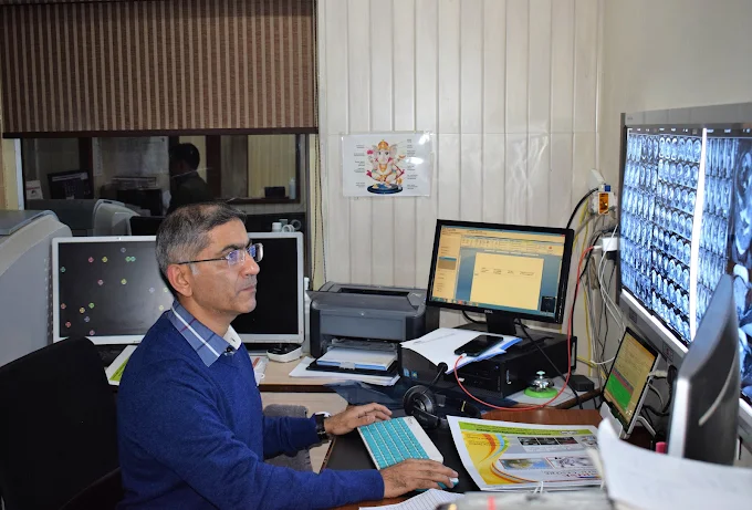 Dr. Anurag Tandon reviewing diagnostic scans at Sunrise Diagnostic Centre